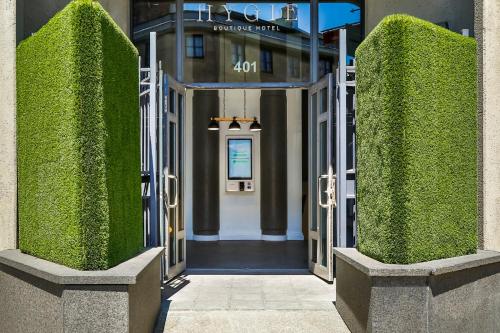 a view of the entrance to a building with green hedges at Hygie Boutique Hotel in Montréal