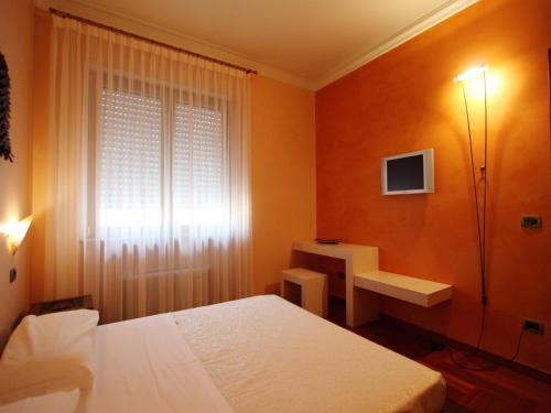 a bedroom with a bed and a sink and a window at Casa Dei Mercanti Town House in Lecce