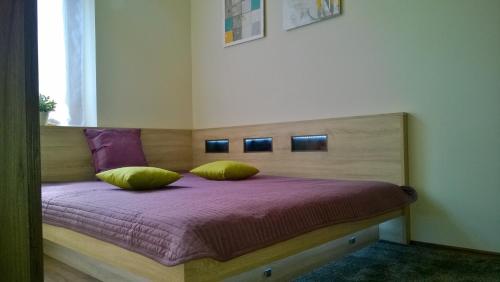 a bed with two pillows on it in a room at Apartment Pertu in Budapest