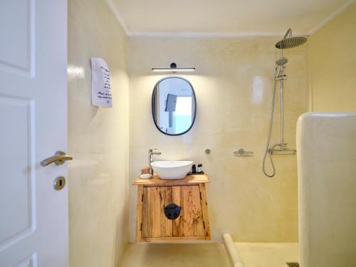 a bathroom with a sink and a mirror at Bonatsa Beach House in Kimolos