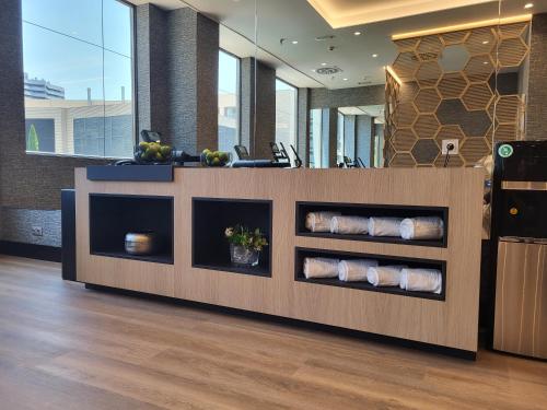 an office lobby with a reception counter with towels at Ilunion Valencia 3 in Valencia