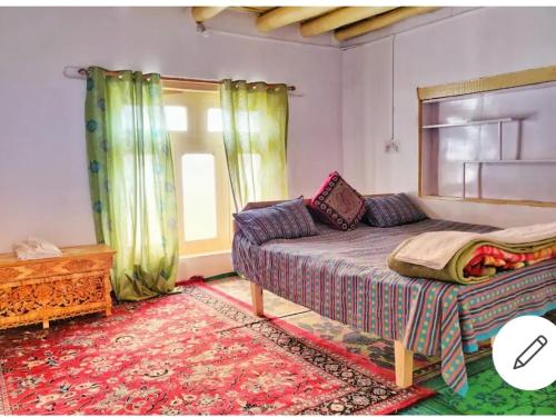 a bedroom with a bed and a window at amir homestay in Leh