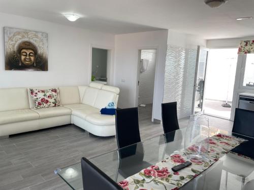 a living room with a glass table and a couch at Adeje Deluxe Villas Santa Mónica in Adeje