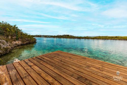 a view of a river with a wooden dock at Chalk Sound Beach Residences Near Sapodilla Bay Beach by Angel Host! in Providenciales