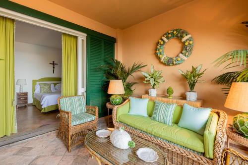 een woonkamer met een bank, stoelen en een bed bij Extraordinary view with a Cobalt pool on the Tuscany coast in Porto Ercole