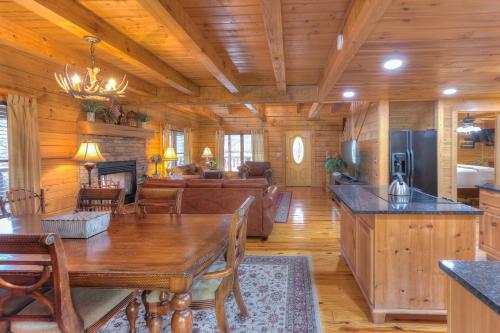 a dining room and living room in a log cabin at RiverStone Condo Resort & Spa in Pigeon Forge