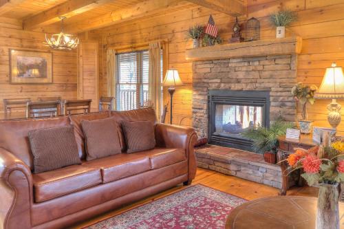 a leather couch in a living room with a fireplace at RiverStone Condo Resort & Spa in Pigeon Forge