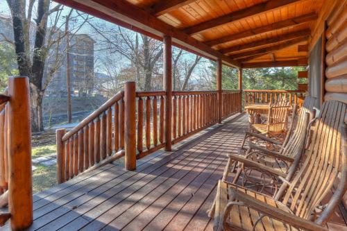 a porch with rocking chairs and a table on it at RiverStone Condo Resort & Spa in Pigeon Forge