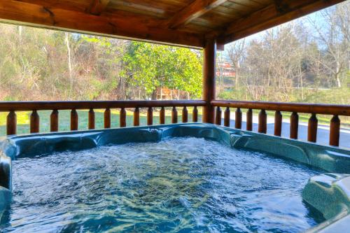 a hot tub on the back of a porch at RiverStone Condo Resort & Spa in Pigeon Forge