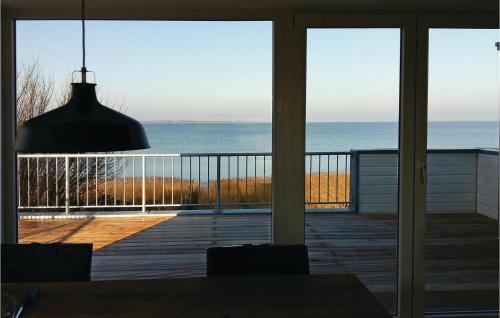 a room with a view of the ocean from a balcony at Mareby in Olpenitz