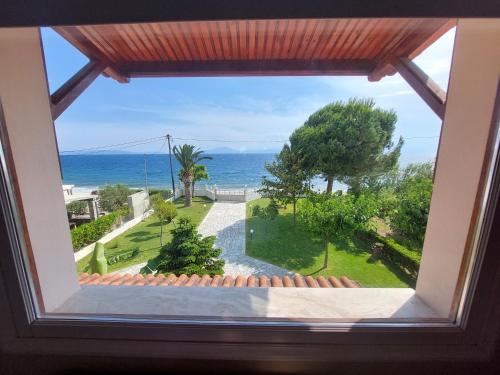a window view of the ocean from a house at Platanidia Apartment Pelion in Platanidia