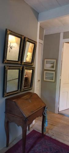 a room with a table and some pictures on the wall at Bérard in Intres