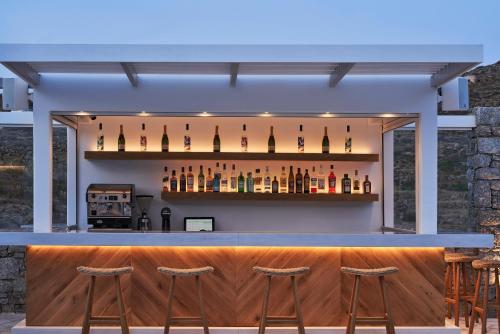 a bar with a row of wine bottles at Paradise View Hotel in Paradise Beach