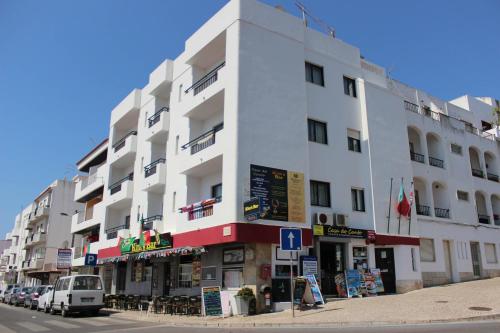 a large white building on the side of a street at Casa Do Canto in Albufeira