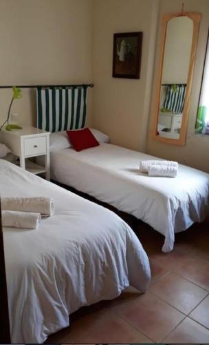 a room with two beds and a table with a mirror at VUT Casa Helen in Ávila