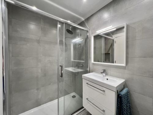 a bathroom with a shower and a sink and a mirror at Armação De Pêra Brightness 2 With Pool by Homing in Armação de Pêra