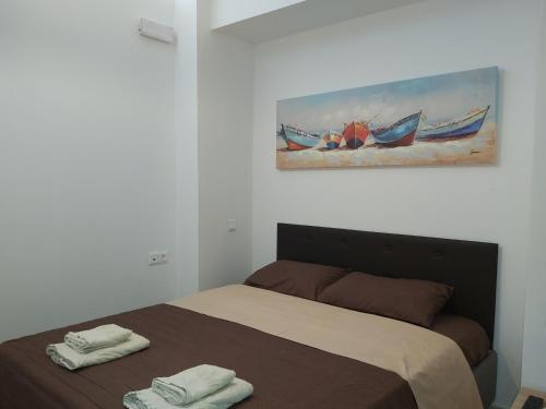 a bedroom with a bed with two towels on it at Villa Maria Sea View by Estia in Balíon