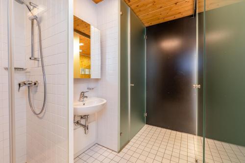 a bathroom with a sink and a shower with a glass door at Holzboxen Planneralm in Planneralm