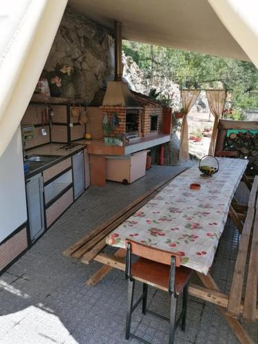 a large kitchen with a table and a stove at MyStay - Quinta do Tendeiro in Guarda