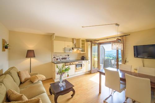 a living room with a couch and a table at Waldvilla BERGSEE in Bodensdorf