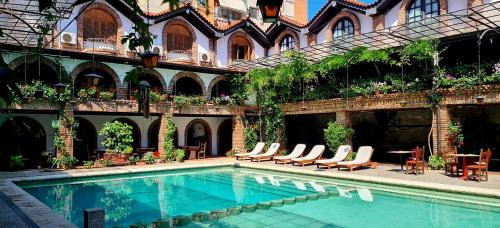 a swimming pool in the courtyard of a building at Hotel Restaurant Bujtina e Gjelit in Tirana
