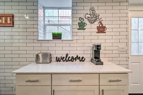 a kitchen with white brick walls and a counter top at 1 Mi to Riverwalk Downtown Reno Studio with Patio! in Reno
