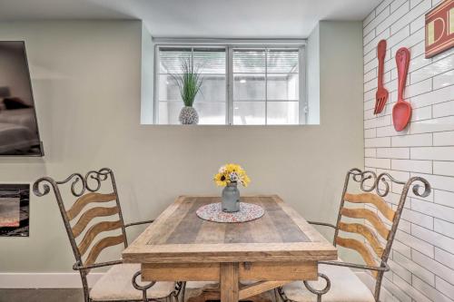 a dining room with a wooden table and two chairs at 1 Mi to Riverwalk Downtown Reno Studio with Patio! in Reno