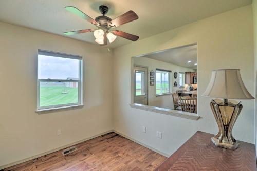 a living room with a ceiling fan and a lamp at Columbia Falls Home with 1-Acre Yard and Views! in Columbia Falls