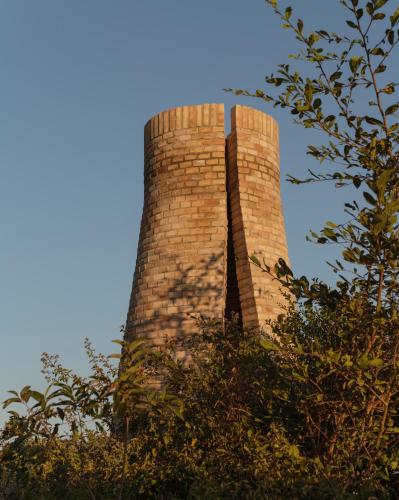 a brick tower with a blue sky in the background at Terrestre, a Member of Design Hotels in Puerto Escondido