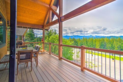 a large deck with a table and chairs on it at Pool Access Cle Elum Mtn-View Cabin with Game Room in Cle Elum