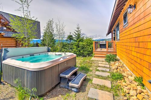 a hot tub in a yard next to a house at Pool Access Cle Elum Mtn-View Cabin with Game Room in Cle Elum