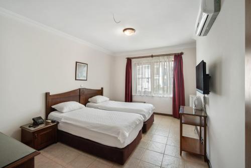 Katil atau katil-katil dalam bilik di Fora Apart Hotel
