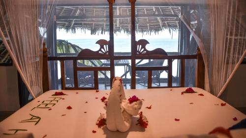 a table with some food on it with a view of the ocean at Villa Malaika in Jambiani