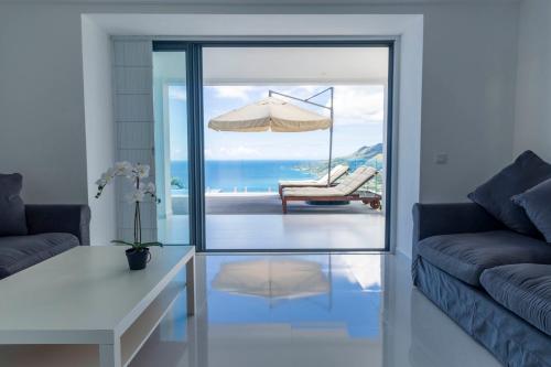 a living room with a view of the ocean at Paradise Heights Luxury Apartments & Villa in Beau Vallon