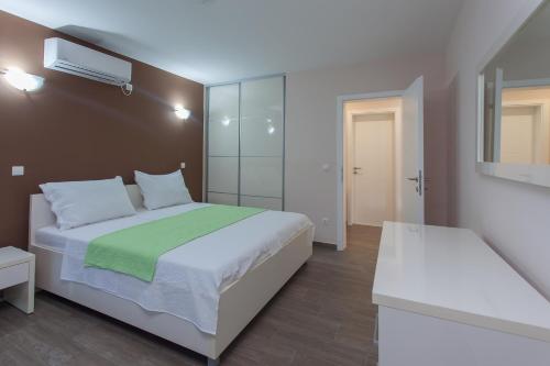 a bedroom with a large bed and a mirror at Buna Spring Apartments in Mostar