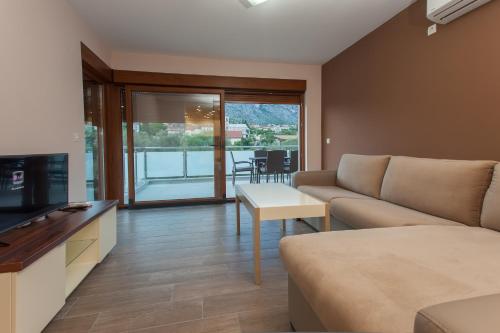 a living room with a couch and a table at Buna Spring Apartments in Mostar