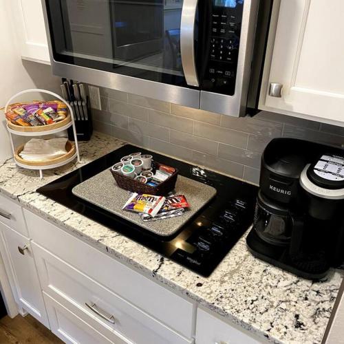 a kitchen counter with a stove top with a microwave at STARLANDING, 2 Kngs/2 Twns; DT/Museums/Trails in Bentonville