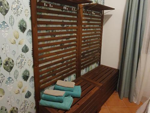 una panca di legno con asciugamani in camera di CASA BIJOUX a Olbia