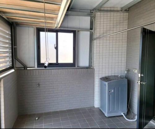 a bathroom with a shower stall and a window at Gaomei 607 Homestay in Qingshui