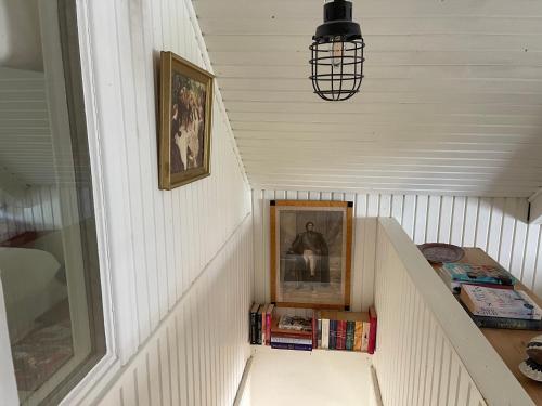 a stairway with a picture and books in a box at Pia's House in Gothenburg