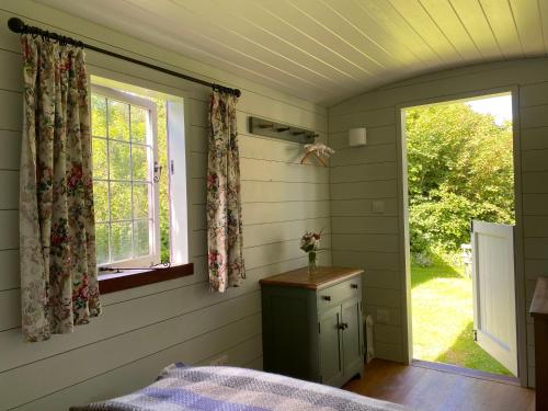 a bedroom with a bed and a window and a table at Shepherds Rest Bruton in Bruton