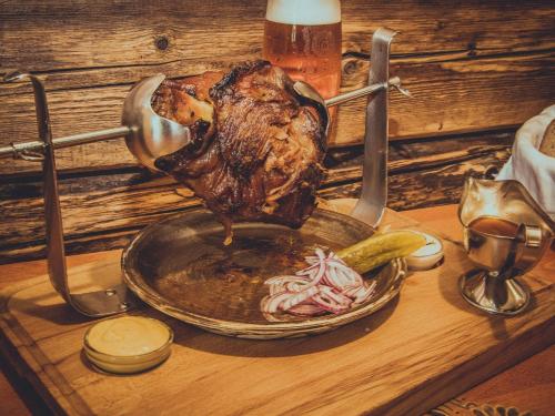 a turkey on a table with a plate and vegetables at Penzion u Hajneho Bedricha in Harrachov