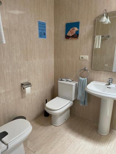 a bathroom with a toilet and a sink at Albaricoque Sun & Beach in Maspalomas