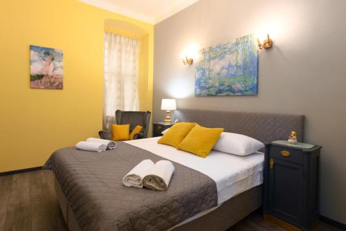 a bedroom with a bed with two towels on it at Apartment Korzo Filodrammatica in Rijeka
