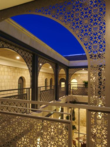 a view of the courtyard of a mosque with blue and white tiles at The Sephardic House Hotel in The Jewish Quarter in Jerusalem