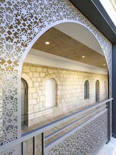 an archway in a building with a patterned wall at The Sephardic House Hotel in The Jewish Quarter in Jerusalem