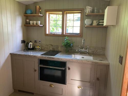 a kitchen with a sink and a counter top at Shepherds Rest Bruton in Bruton