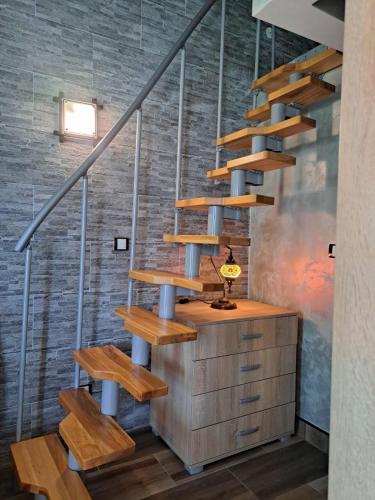 a staircase in a room with a wooden cabinet and stairs at Apartments with sea view in Prcanj in Kotor