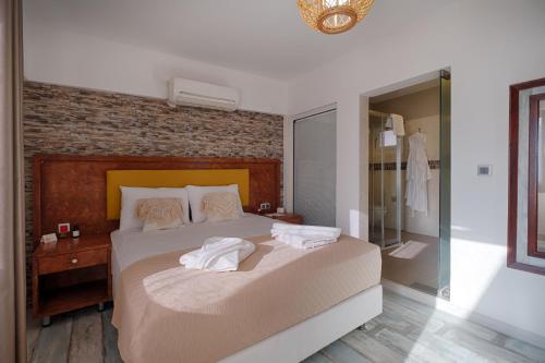 a bedroom with a bed with towels on it at Les Terrasses De Selimiye in Selimiye