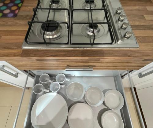 a bunch of pots and pans are in a stove at Holiday Home In Cardiff, Sleeps 8 in Cardiff
